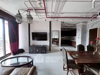 Stylish industrial loft with exposed pipes and modern furnishings