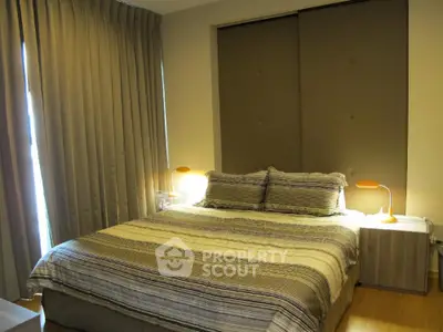 Cozy bedroom with modern decor and warm lighting, perfect for relaxation.