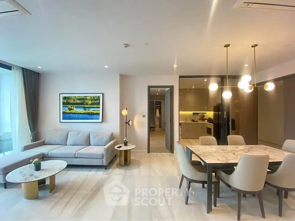 Luxurious open-plan living and dining area with modern decor and elegant lighting