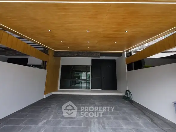 Modern covered parking area with sleek wooden ceiling and tiled flooring