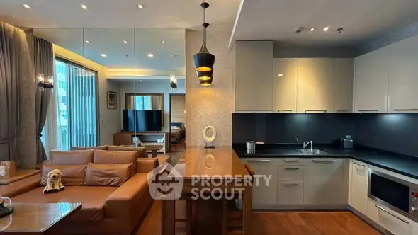 Luxurious open-plan living room and kitchen with modern furnishings and elegant lighting.