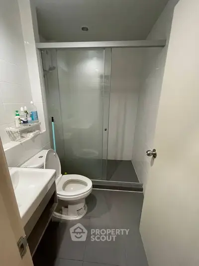 Modern bathroom with sleek shower and contemporary fixtures in a stylish apartment.