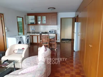 Spacious living room with open kitchen and modern appliances