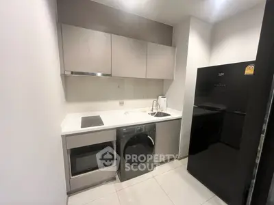 Modern compact kitchen with sleek appliances and minimalist design