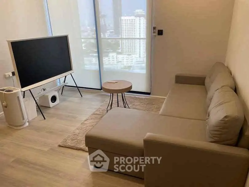Modern living room with stylish furniture and city view, perfect for urban living.
