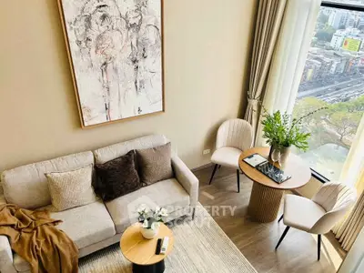 Stylish living room with modern decor and city view from large window.