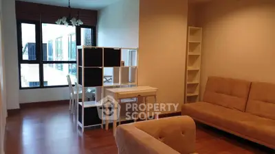 Spacious living room with modern furniture and large window view