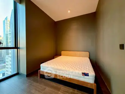 Modern bedroom with large window and city view, featuring a minimalist design and comfortable bed.