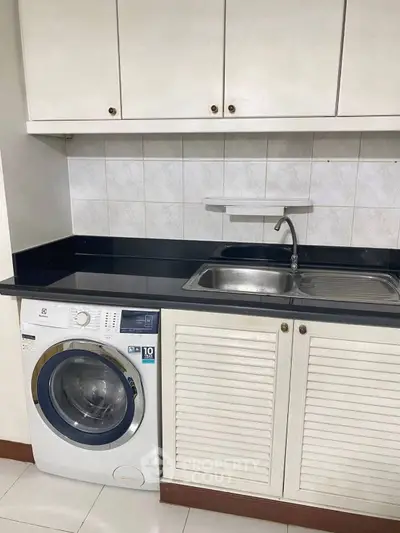 Modern kitchen with built-in washing machine and sleek cabinetry