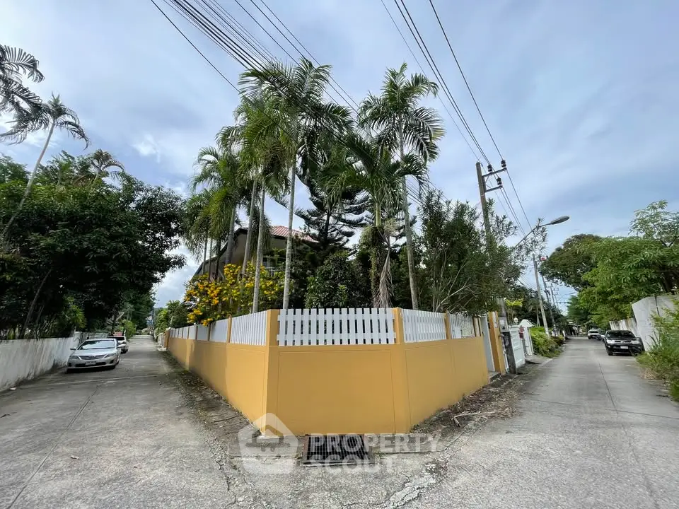 Charming corner property with lush greenery and modern fencing in a serene neighborhood.