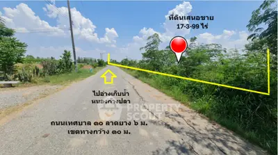Scenic land plot for sale with clear road access and lush greenery