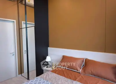 Modern bedroom with stylish decor and mirrored wardrobe