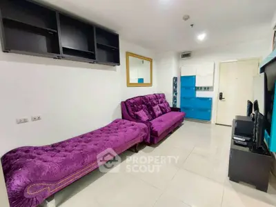Modern living room with vibrant purple sofa and sleek storage solutions.