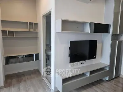 Modern living room with sleek built-in shelves and wall-mounted TV
