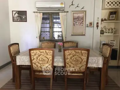 Elegant dining room with classic wooden table and chairs, adorned with decorative art and cozy ambiance.