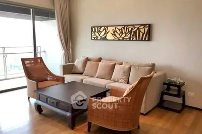 Spacious living room with elegant decor and large balcony access