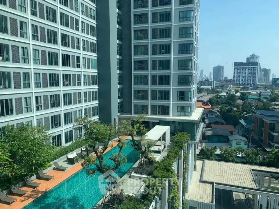 Luxurious high-rise building with stunning pool and city view, perfect for urban living.
