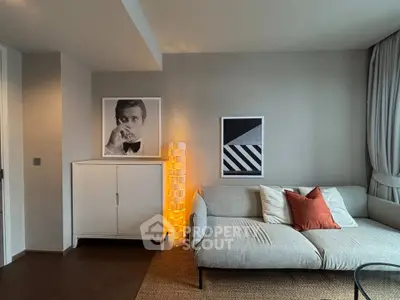 Modern living room with stylish decor, featuring a cozy sofa, artistic wall art, and ambient lighting.
