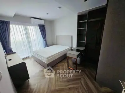 Modern bedroom with large window and stylish flooring