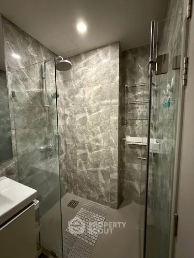 Modern bathroom with glass shower and elegant marble tiles