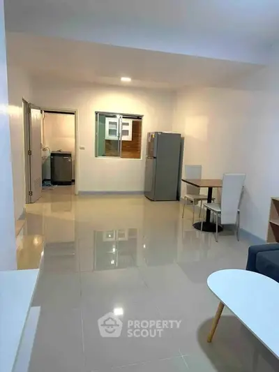 Spacious modern living room with sleek furniture and glossy tiled floors