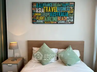Cozy bedroom with stylish decor and travel-themed wall art, perfect for relaxation.