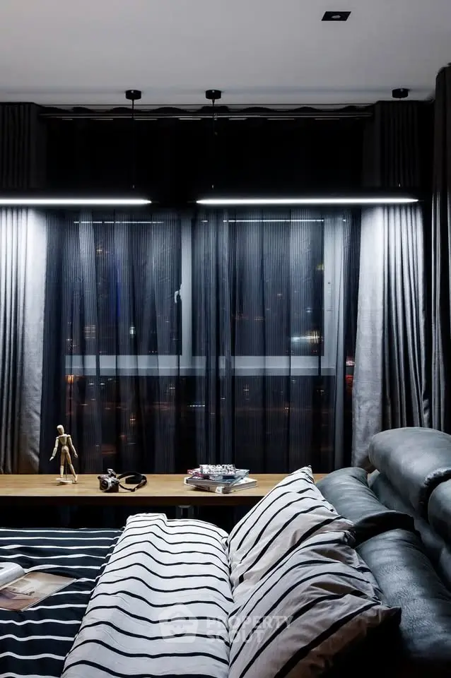 Modern bedroom with stylish decor and city view through large window.