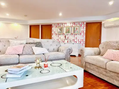 Spacious living room with elegant decor and cozy seating area.