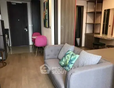 Modern living room with stylish decor and cozy seating in a contemporary apartment.