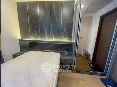 Modern bedroom with stylish marble accent wall and sleek design