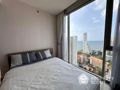 Stunning bedroom with panoramic ocean view in high-rise apartment