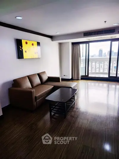 Spacious living room with city view and modern furnishings