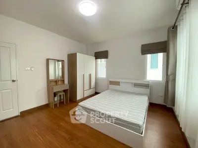 Spacious bedroom with modern furnishings and natural light