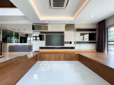 Modern living room with sleek wooden flooring and built-in shelving