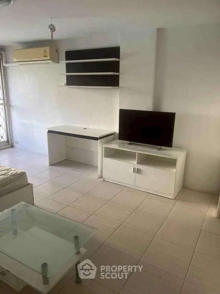 Modern living room with sleek furniture and air conditioning in a bright apartment.