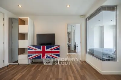 Modern living room with unique Union Jack TV stand and wooden flooring