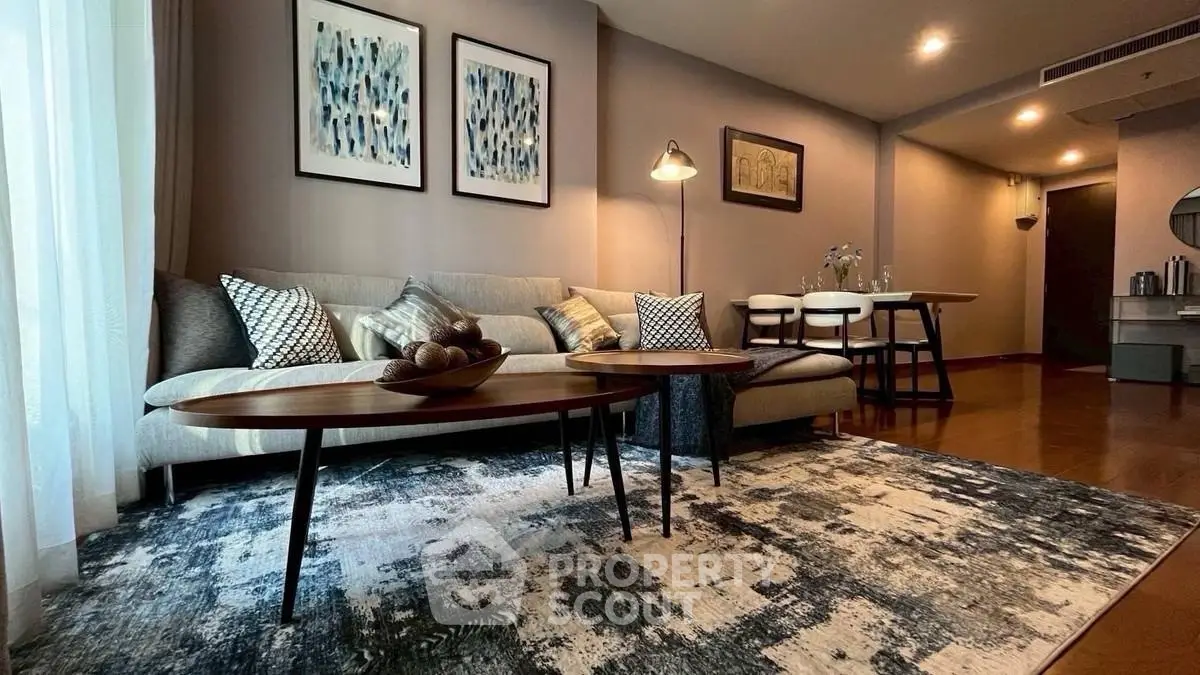 Stylish living room with modern decor and cozy ambiance, featuring elegant furniture and artistic wall accents.