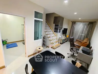 Modern living room with dining area and staircase in a cozy home