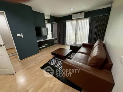 Modern living room with leather sofa, TV, and large windows in stylish apartment.