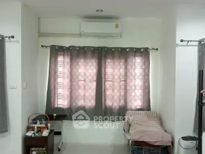 Cozy bedroom with air conditioning and stylish curtains, perfect for relaxation and comfort.
