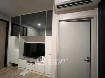Modern living room with sleek built-in storage and air conditioning
