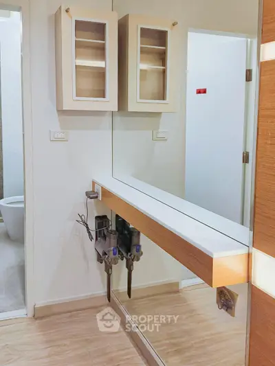 Modern bathroom with sleek design and mirrored wall, featuring a contemporary floating vanity.