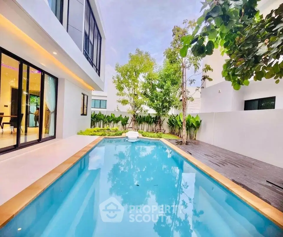 Luxurious modern home with private pool and lush garden view