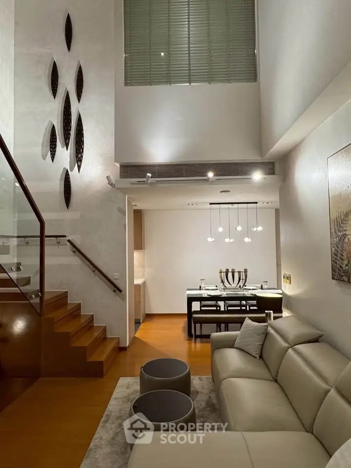 Luxurious modern living room with high ceiling and elegant decor