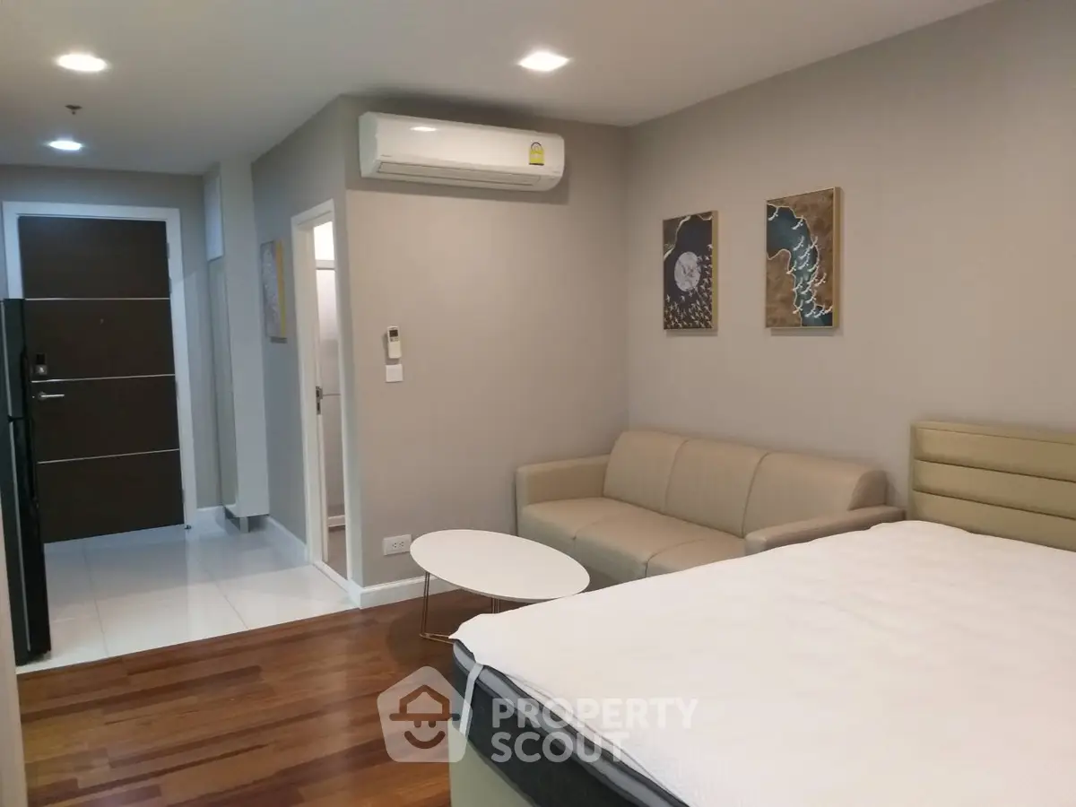 Modern studio apartment with cozy living area and stylish decor