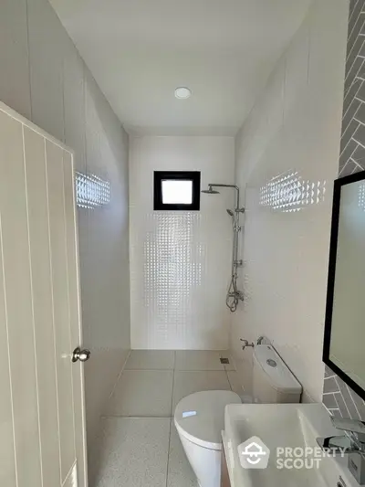 Modern minimalist bathroom with sleek fixtures and natural light