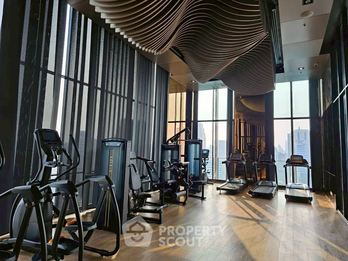 Luxurious high-rise gym with modern equipment and stunning city views.