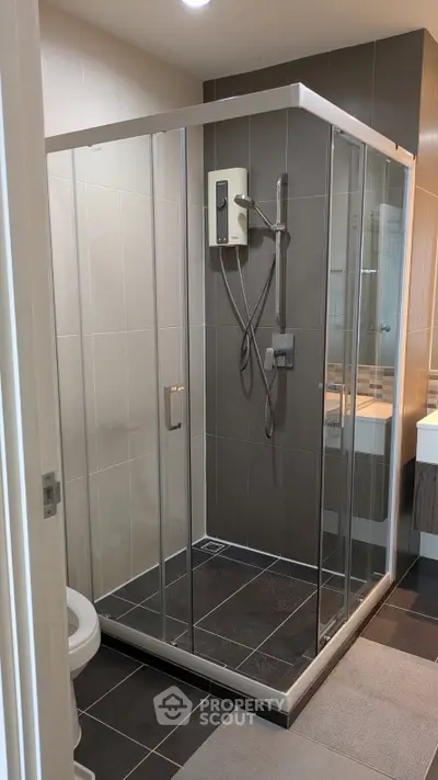 Modern bathroom with glass shower enclosure and sleek fixtures