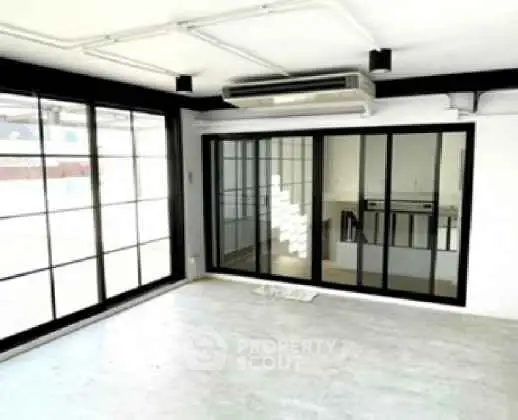 Spacious modern living room with large windows and sleek design