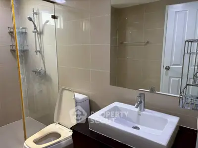 Modern bathroom with sleek fixtures and glass shower enclosure